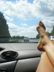 A person’s feet on the dashboard
