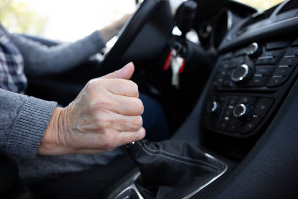 A person’s hand clutching a gear stick