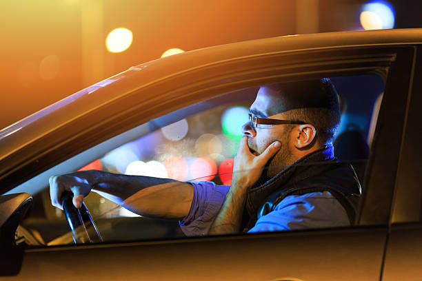 A man driving and looking shocked