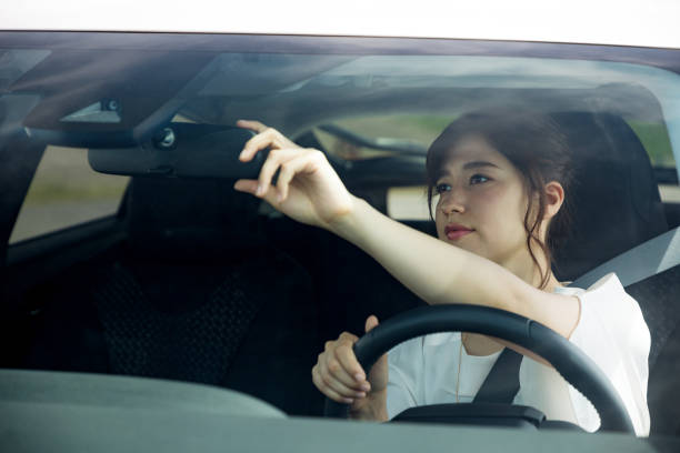 A girl fixing her rear-view mirror